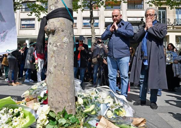 Parisians leave floral tributes on the Champs Elysees following yesterdays shooting  in which a police officer was killed two more injured. Picture: Getty Images