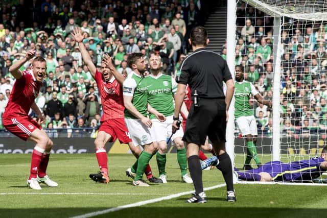 Hibernian goalkeeper Ofir Marciano tries to claw back the ball Aberdeen's Ryan Christie scores from the freekick. Pic: SNS/Bill Murray