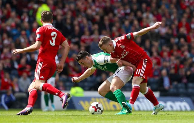 Hibernian's John McGinn and Aberdeen's Jonny Hayes battle for the ball. Pic: Andrew Milligan/PA Wire.
