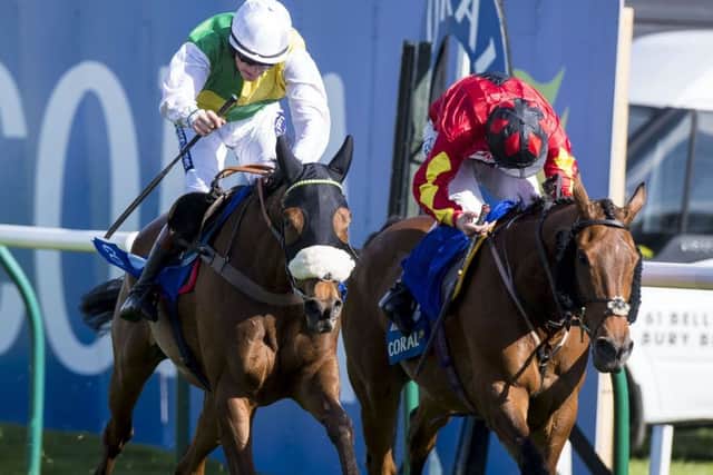 Vicente, left, ridden by Sam Twiston-Davies, edged out Cogry  trained by the winning jockeys father, Nigel  to win the Scottish Grand National. Picture: Craig Watson/PA