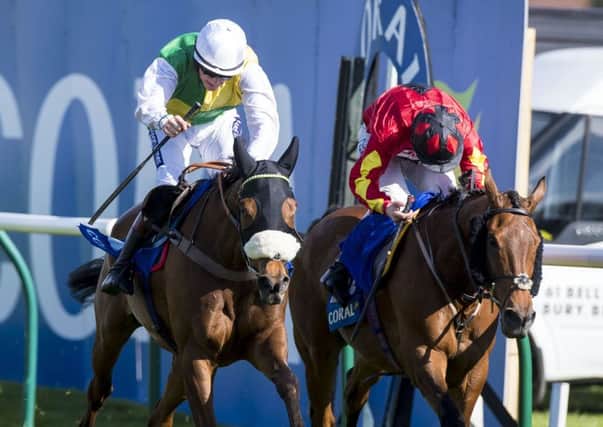 Vicente, left, ridden by Sam Twiston-Davies, edged out Cogry  trained by the winning jockeys father, Nigel  to win the Scottish Grand National. Picture: Craig Watson/PA