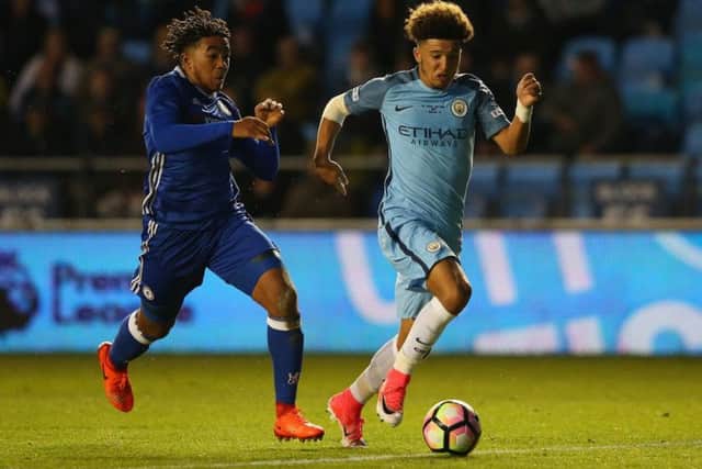 Jadon Sancho, right, holds off Chelsea's Reece James in the recent FA Youth Cup Final First Leg match at The Academy Stadium. Picture: Getty Images