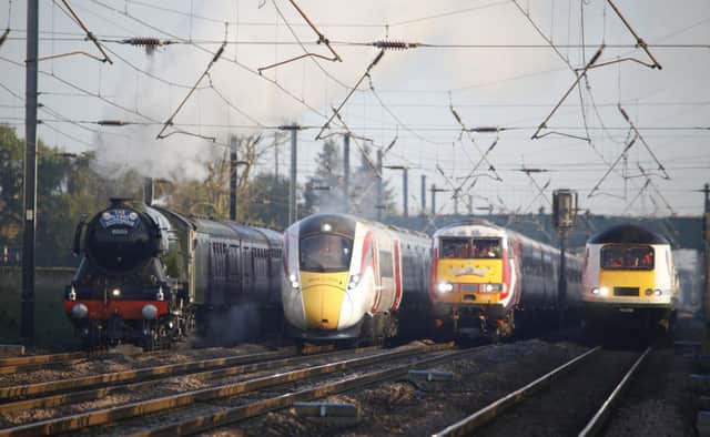 The Flying Scotsman and Virgin Trains' new Azuma travel together to depict the past, present and future of UK rail travel. Picture: PA