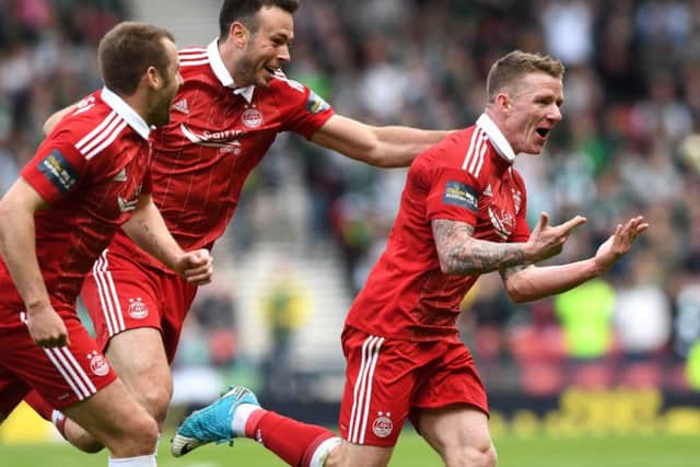 Aberdeen's Jonny Hayes, right, wheels away after his late goal against Hibs in the Scottish Cup semi-final. Picture: SNS