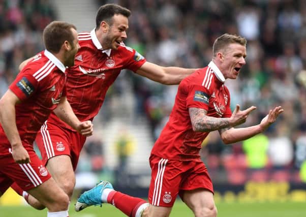 Aberdeen's Jonny Hayes, right, wheels away after his late goal against Hibs in the Scottish Cup semi-final. Picture: SNS