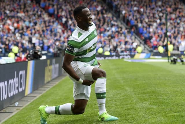 Celtic's Moussa Dembele feels his hamstring after pulling up with an injury. Picture: SNS