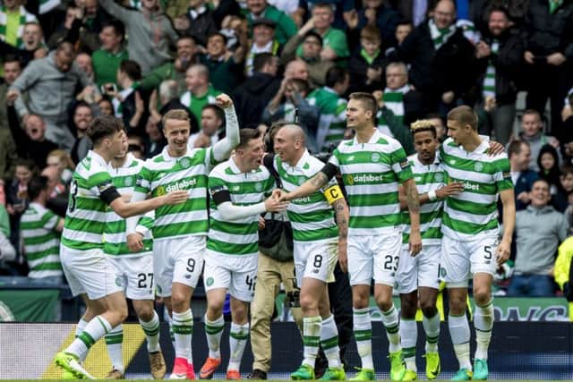 Celtic players celebrate after Scott Sinclair converted Celtic's 51st minute penalty. Picture: SNS