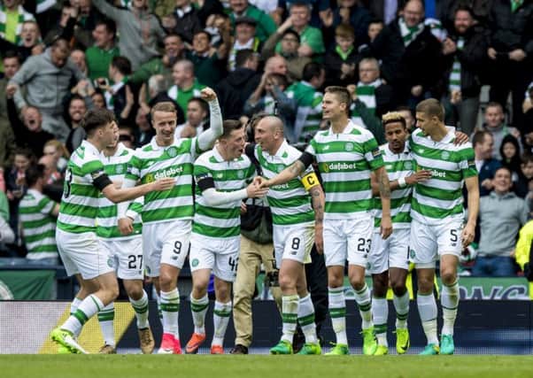 Celtic players celebrate after Scott Sinclair converted Celtic's 51st minute penalty. Picture: SNS