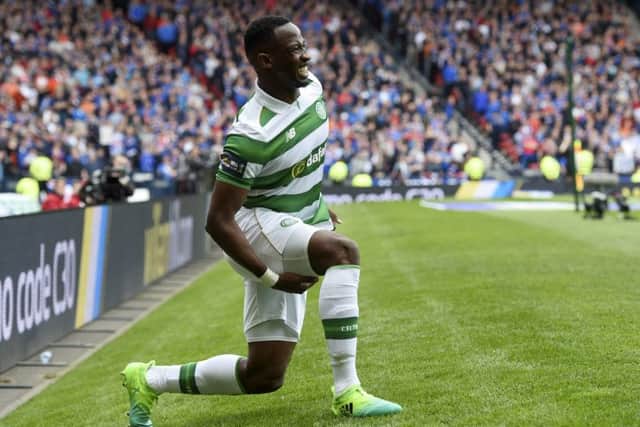 Moussa Dembele clutches his hamstring after injuring it against Rangers. Pic: SNS