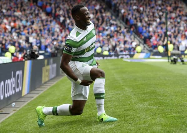 Moussa Dembele clutches his hamstring after injuring it against Rangers. Pic: SNS