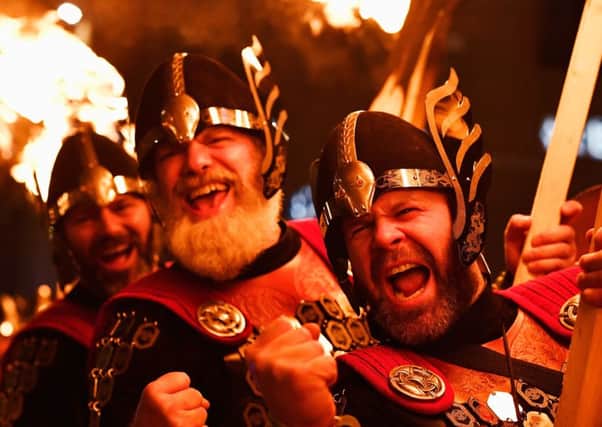 Vikings take part 
during a torchlight procession through Edinburgh. (Photo by Jeff J Mitchell/Getty Images)