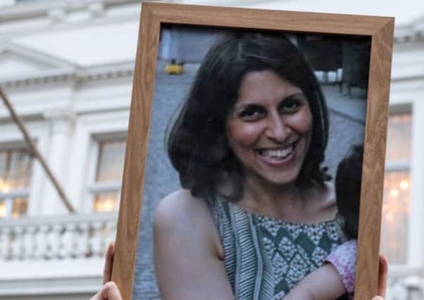 Supporters hold a photo of Nazanin Zaghari-Ratcliffe during a vigil for British-Iranian motherPicture: Chris J Ratcliffe/Getty Images