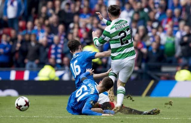 Patrick Roberts, right, is taken out by Andy Halliday, left. Picture: SNS