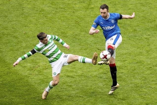 Danny Wilson, right, goes in for a challenge with Celtic midfielder Patrick Roberts. Picture: SNS