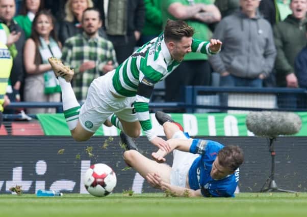 Patrick Roberts is sent flying by a challenge from Andy Halliday at Hamden on Sunday. Picture: Ian Sneddon/Universal News And Sport (Scotland)