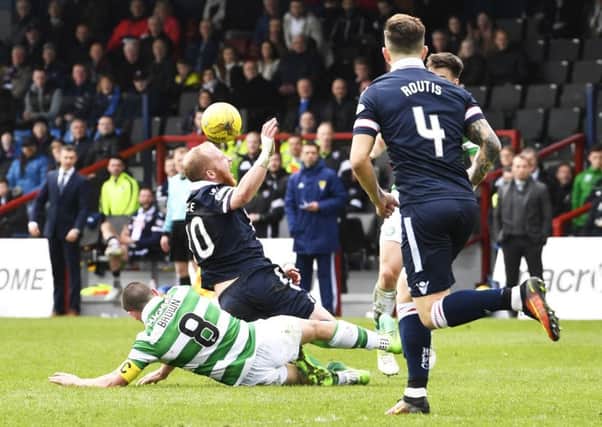Scott Brown chops down Liam Boyce during Celtic's draw with Ross County. Picture: SNS