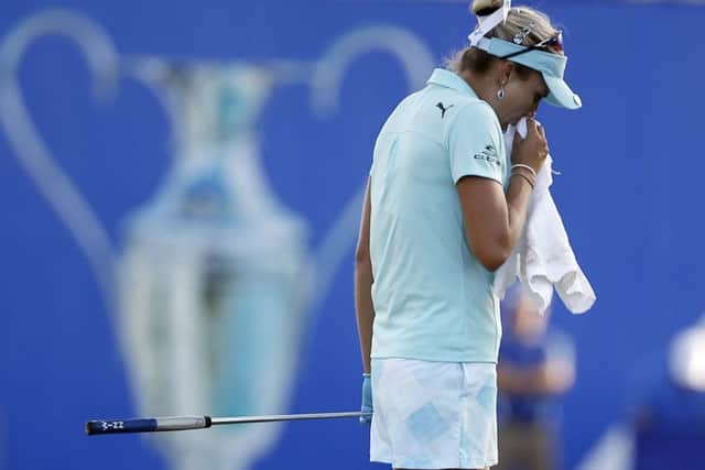 Lexi Thompson, who was hit with a four-shot penalty, composes herself on the 18th green during the final round of the ANA Inspiration. Picture: AP