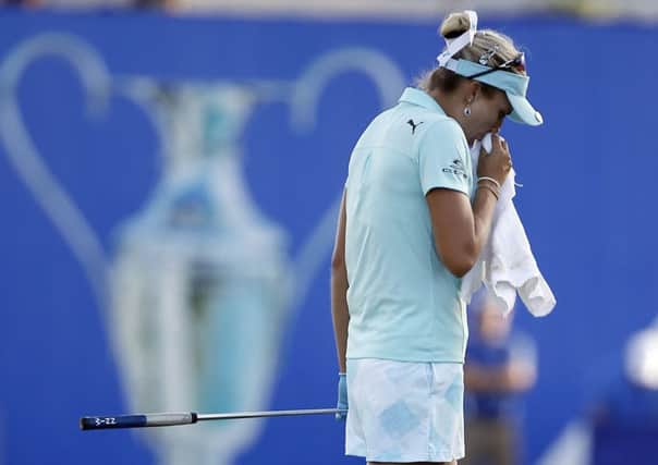 Lexi Thompson, who was hit with a four-shot penalty, composes herself on the 18th green during the final round of the ANA Inspiration. Picture: AP