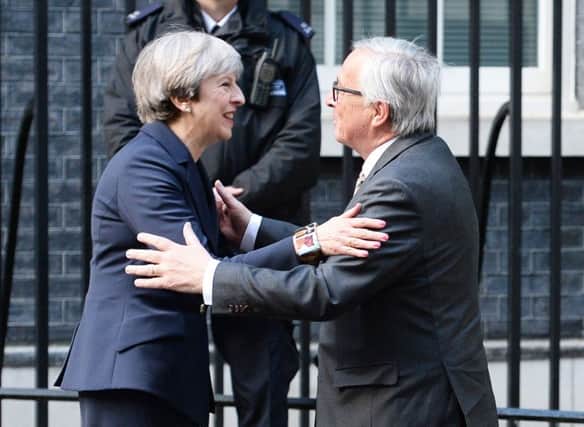 Theresa May greets European Commission President Jean-Claude Juncker ahead of a Brexit meeting. Picture: John Stillwell/PA Wire