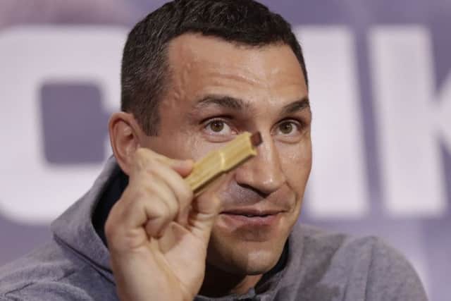 Wladimir Klitschko holds up a USB stick he said he's recorded his fight prediction on during a press conference with Anthony Joshua. Picture: AP