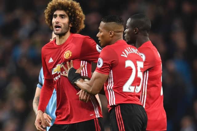 Manchester United midfielder Marouane Fellaini, left, reacts after being sent off for headbutting Manchester City striker Sergio Aguero. Picture: AFP/Getty