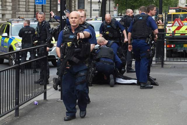 Police arrest a man on Whitehall near the Houses of Parliament in central London. Picture; getty