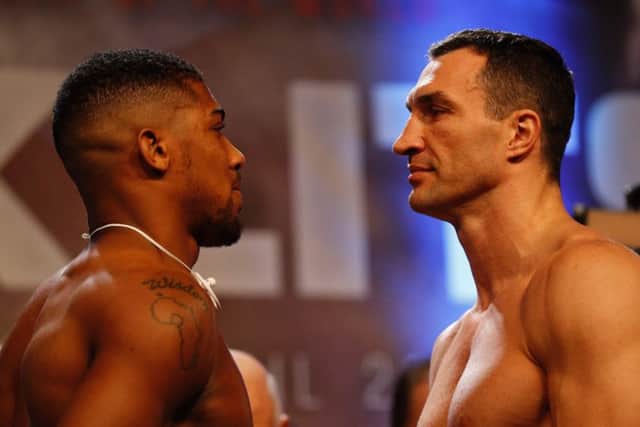 Anthony Joshua, left, and Wladimir Klitschko face each other during the weigh-in. Picture: Adrian Dennis/AFP/Getty Images