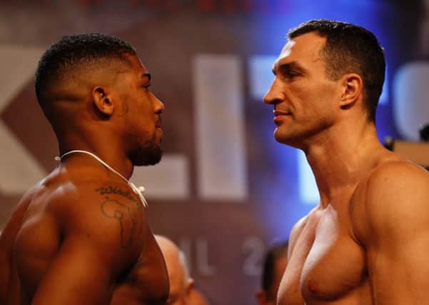 Anthony Joshua, left, and Wladimir Klitschko face each other during the weigh-in. Picture: Adrian Dennis/AFP/Getty Images
