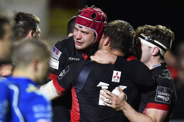 Grant Gilchrist celebrates with team-mates after his late lunge for the line gave Edinburgh victory. Picture: SNS.