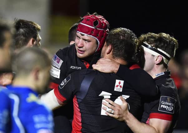 Grant Gilchrist celebrates with team-mates after his late lunge for the line gave Edinburgh victory. Picture: SNS.