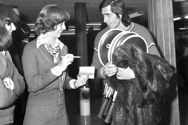 Ilie Nastase, fur coat over his arm, arrives at Turnhouse Airport in 1975 where an air hostess asks him for his autograph. Picture: Jack Crombie