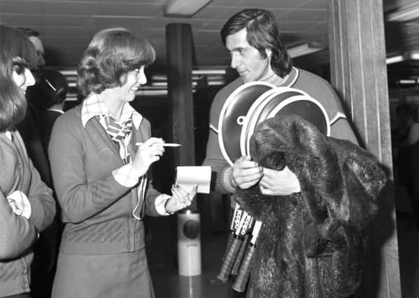 Ilie Nastase, fur coat over his arm, arrives at Turnhouse Airport in 1975 where an air hostess asks him for his autograph. Picture: Jack Crombie