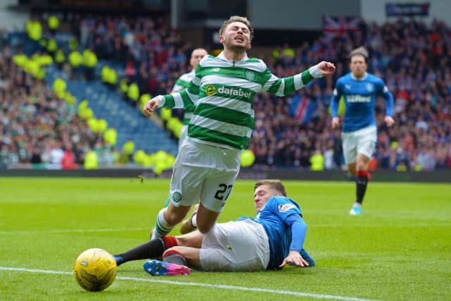 Myles Beerman fouls Patrick Roberts (left) and concede a penalty. Pic: SNS/Alan Harvey