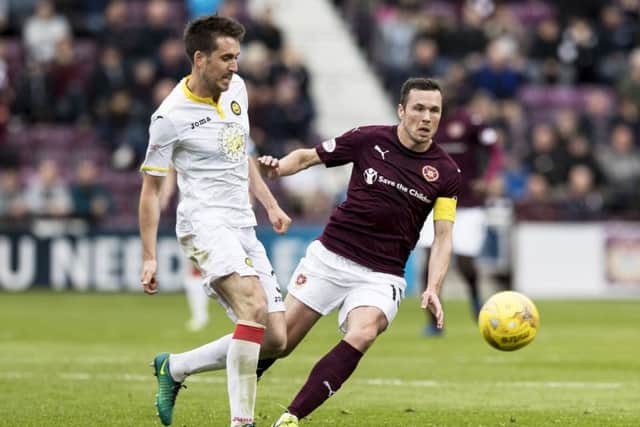 Partick Thistle's Callum Booth and Hearts' Don Cowie  in action. Pic: SNS/Alan Rennie