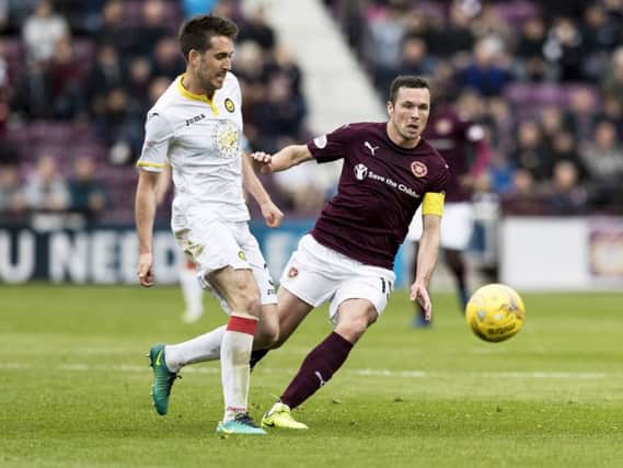 Partick Thistle's Callum Booth and Hearts' Don Cowie  in action. Pic: SNS/Alan Rennie