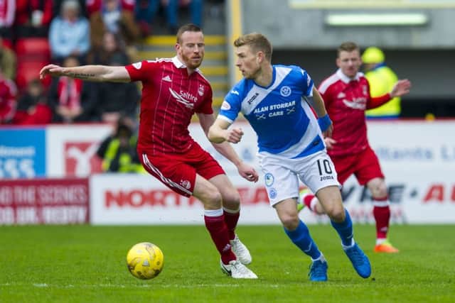 Aberdeen's Adam Rooney battles for the ball against St Johnstone's David Wotherspoon. Pic: SNS/Sammy Turner