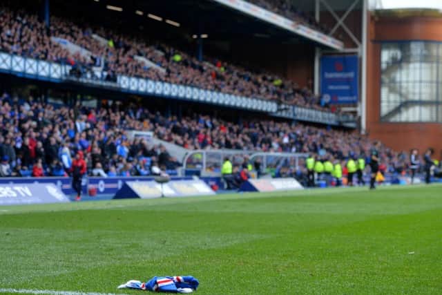 A scarf lies on the Ibrox pitch. Pic: Mark Runnacles/Getty Images