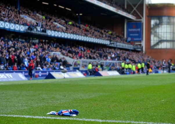 A scarf lies on the Ibrox pitch. Pic: Mark Runnacles/Getty Images