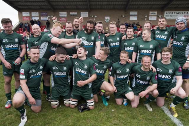 The victorious Hawick team celebrate their comeback from 20-6 down to win by three points, keeping them in the top tier of Scottish rugby. Photograph: Ian Rutherford