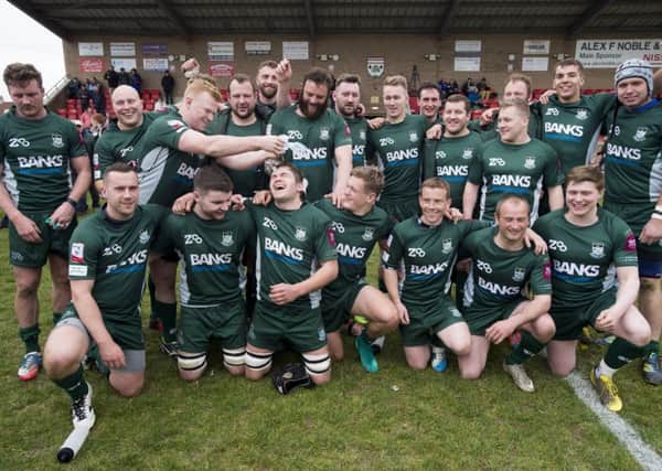 The victorious Hawick team celebrate their comeback from 20-6 down to win by three points, keeping them in the top tier of Scottish rugby. Photograph: Ian Rutherford