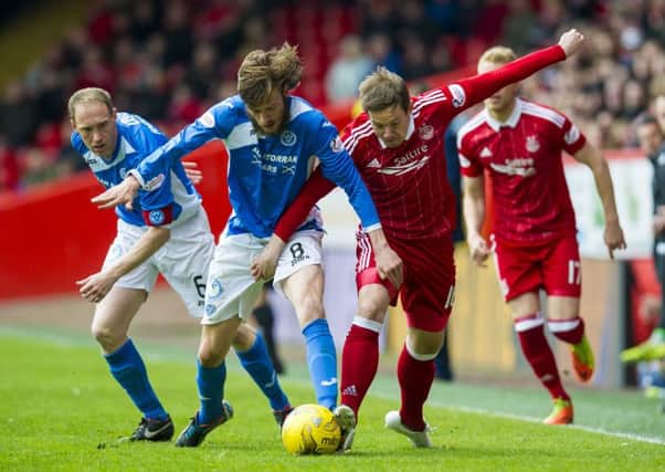 Murray Davidson, left, and Peter Pawlett tussle at Pittodrie. Picture: SNS