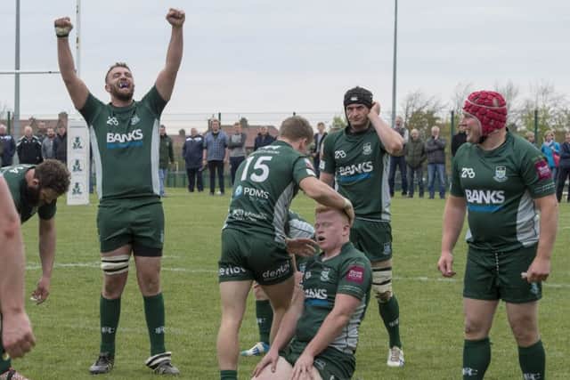 Exhausted Hawick players celebrate at full-time after their 23-20 play-off victory over Edinburgh Accies. Picture: Ian Rutherford