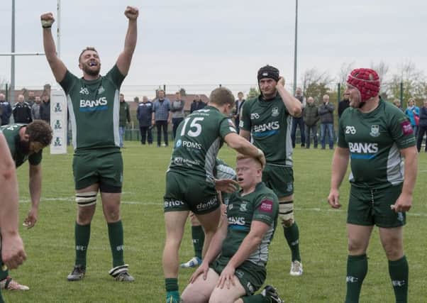 Exhausted Hawick players celebrate at full-time after their 23-20 play-off victory over Edinburgh Accies. Picture: Ian Rutherford