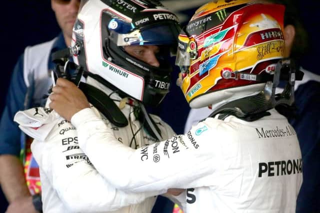 Britain's Lewis Hamilton, right, congratulates his Mercedes team-mate Valtteri Bottas on winning the Russian Grand Prix. Picture: Alexander Demianchuk\TASS