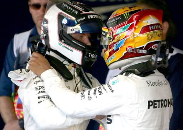 Britain's Lewis Hamilton, right, congratulates his Mercedes team-mate Valtteri Bottas on winning the Russian Grand Prix. Picture: Alexander Demianchuk\TASS