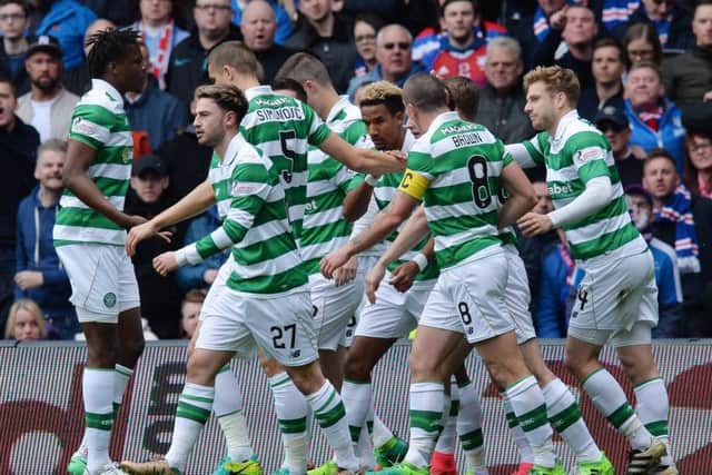 Celtic's players celebrate with Scott Sinclair, centre, after the attacker scores the opening goal of Saturday's match with Rangers. Picture: Getty