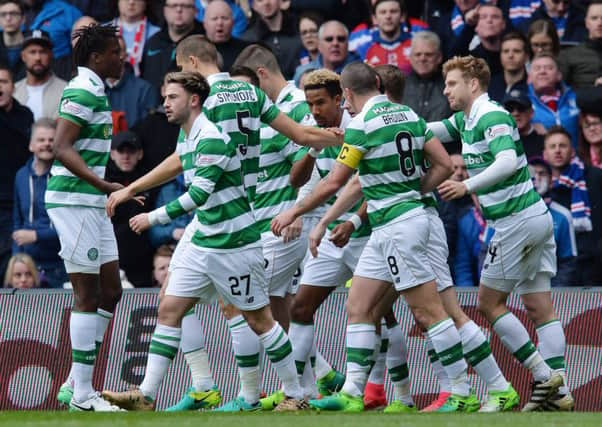 Celtic's players celebrate with Scott Sinclair, centre, after the attacker scores the opening goal of Saturday's match with Rangers. Picture: Getty