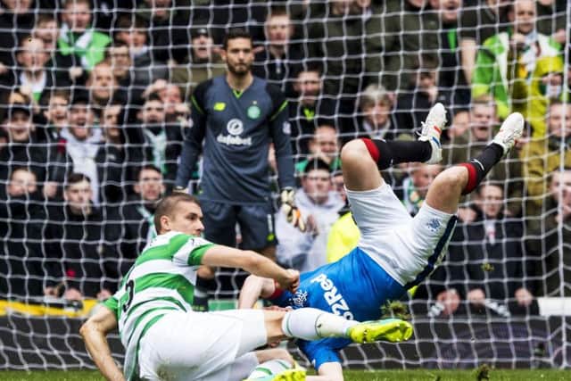 Celtic's Jozo Simunovic challenges Rangers' Kenny Miller. Picture: SNS