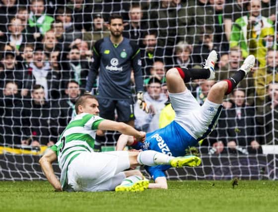 Celtic's Jozo Simunovic challenges Rangers' Kenny Miller. Picture: SNS