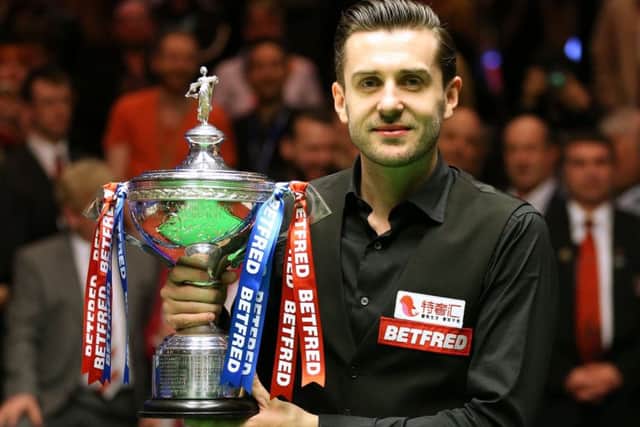 Mark Selby celebrates winning the Betfred Snooker World Championship. Picture: PA